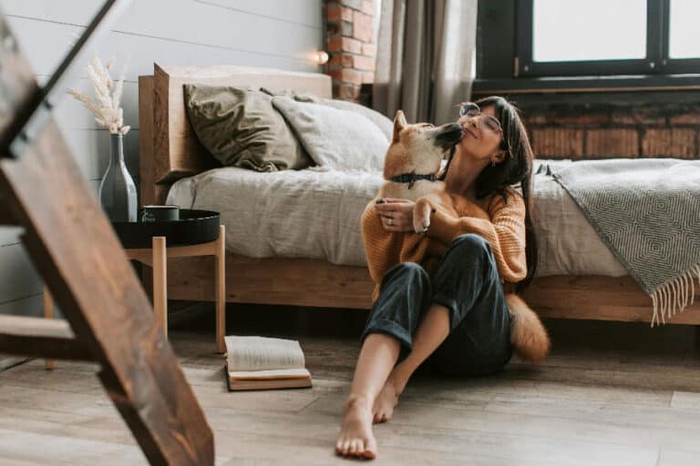 An image of a dog and a woman cuddling, after successful Tampa dog training